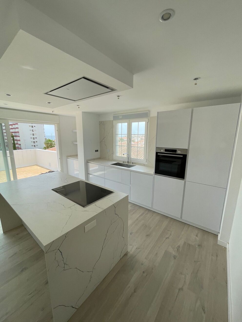 Glossy white kitchen with island